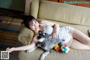 A young woman in a white shirt and a gray skirt.