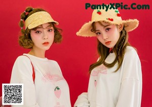 A couple of young women standing next to each other.