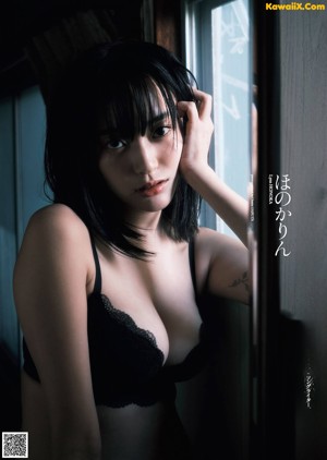 A woman in a black bathing suit standing on a set of stairs.
