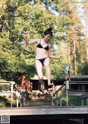 A woman sitting in a boat on a lake.
