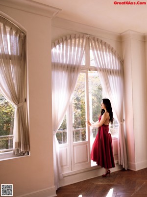 A woman in a red dress is showing off her panties.