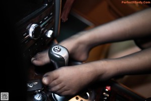 A woman sitting in the driver's seat of a car.