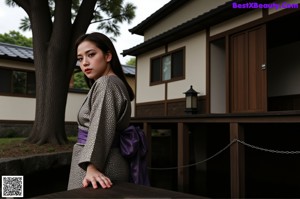 A woman in a purple dress posing for a picture.