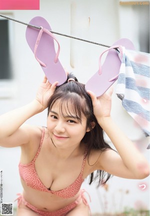 A woman in a swimming pool smiling at the camera.