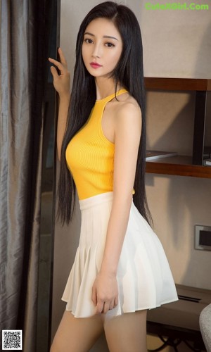 A woman in a white lingerie posing in a bathroom.