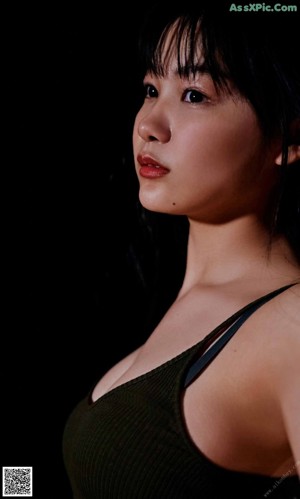 A woman wearing a white bra and black hair.