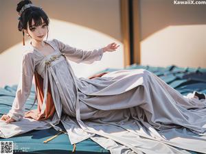 A woman in a white dress sitting on a wooden bench.