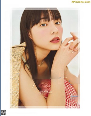 A magazine page with a picture of a woman in a floral dress.