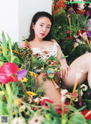 A magazine with a woman holding a bunch of flowers.