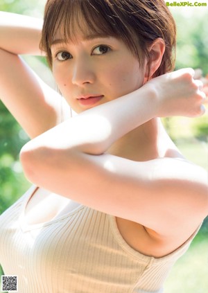A woman in a blue and white bikini posing for a picture.