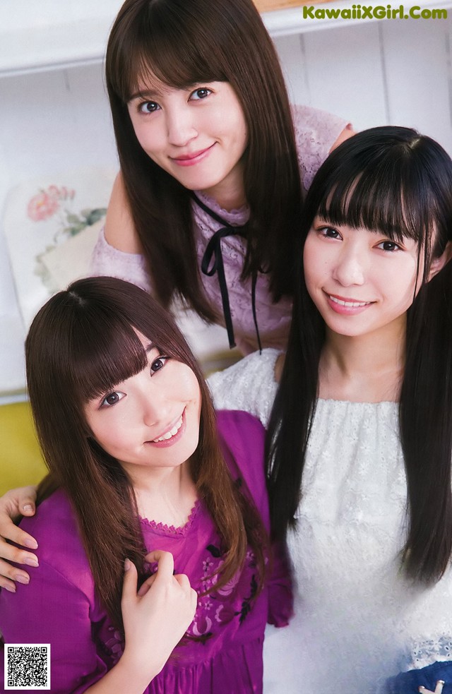 A group of three young women posing for a picture.