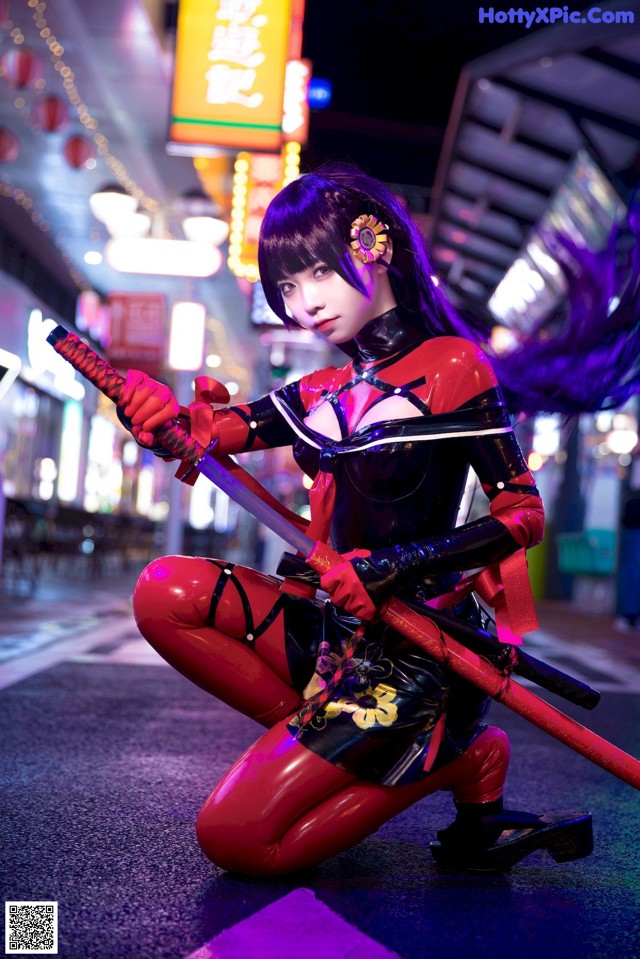 A woman in a red and black outfit holding two swords.